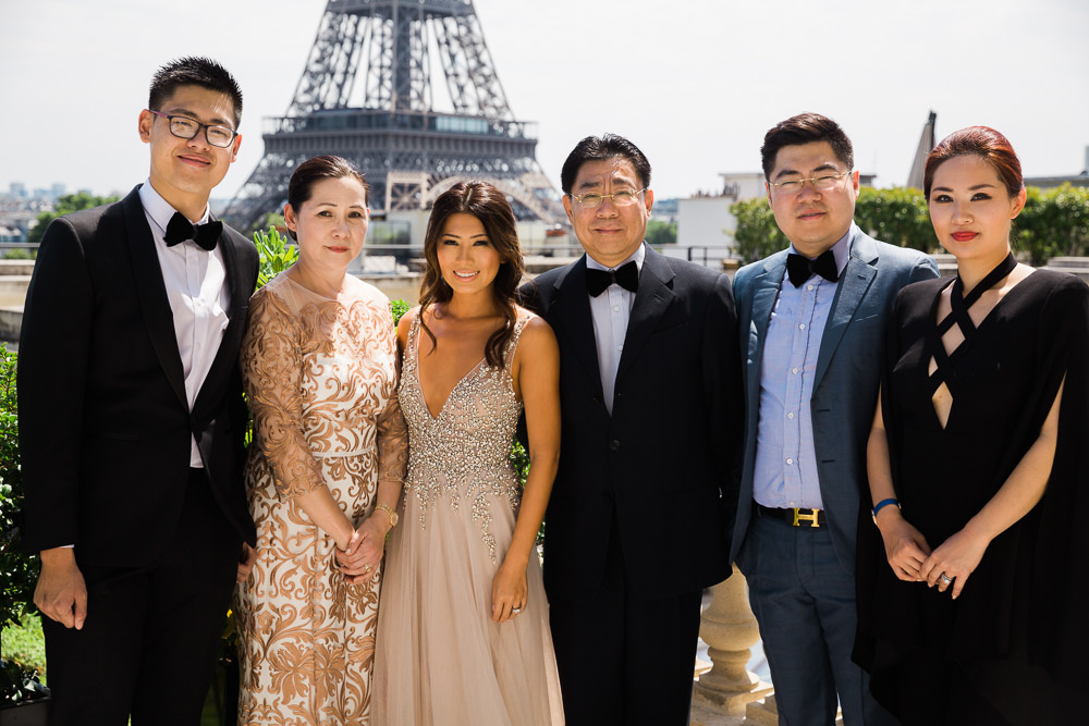 Family portraits at Eiffel Tower during destination wedding in Paris