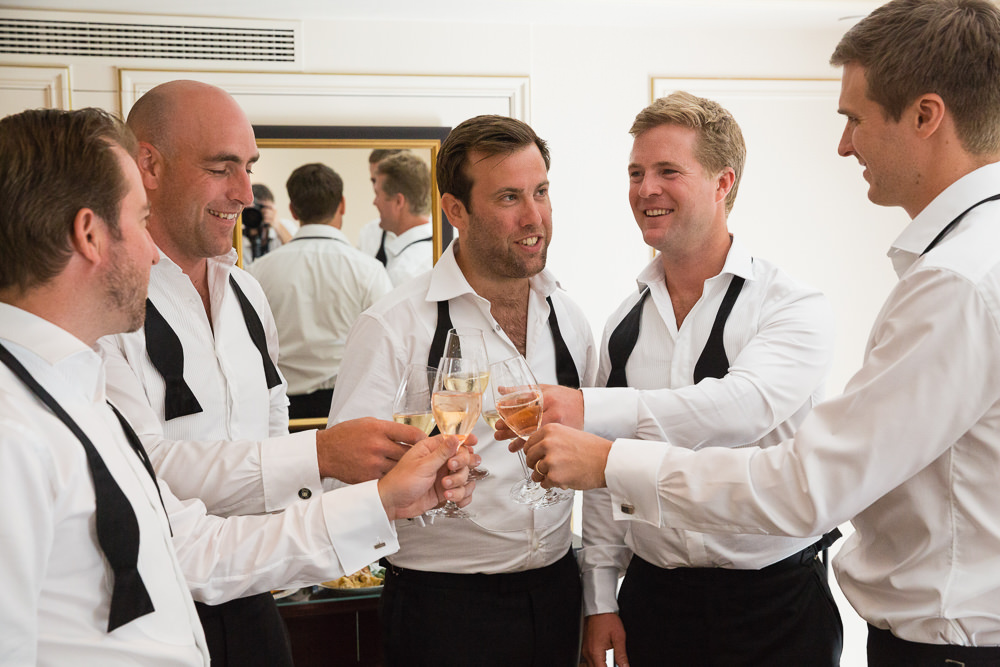 Groom and groomsmen getting ready with champagne glasses