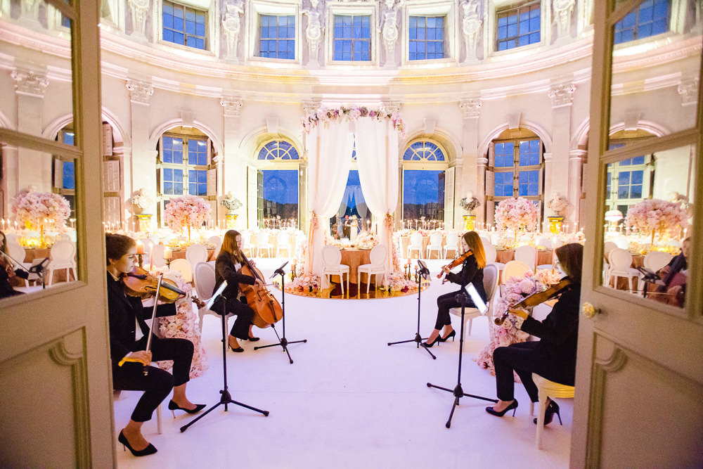 Orchestra playing for reception dinner in private French chateau wedding day