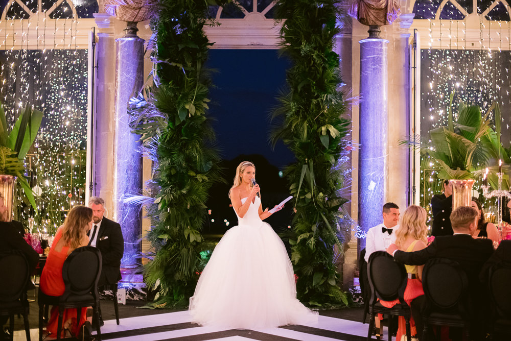 Modern bride having speech during Vaux le Vicomte wedding dinner in a French chateau near Paris